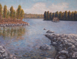 A landscape painting of a horizon, trees, their reflections in a body of water, and a peninsula of rocks in the foreground, painted by Luke Mahoney.